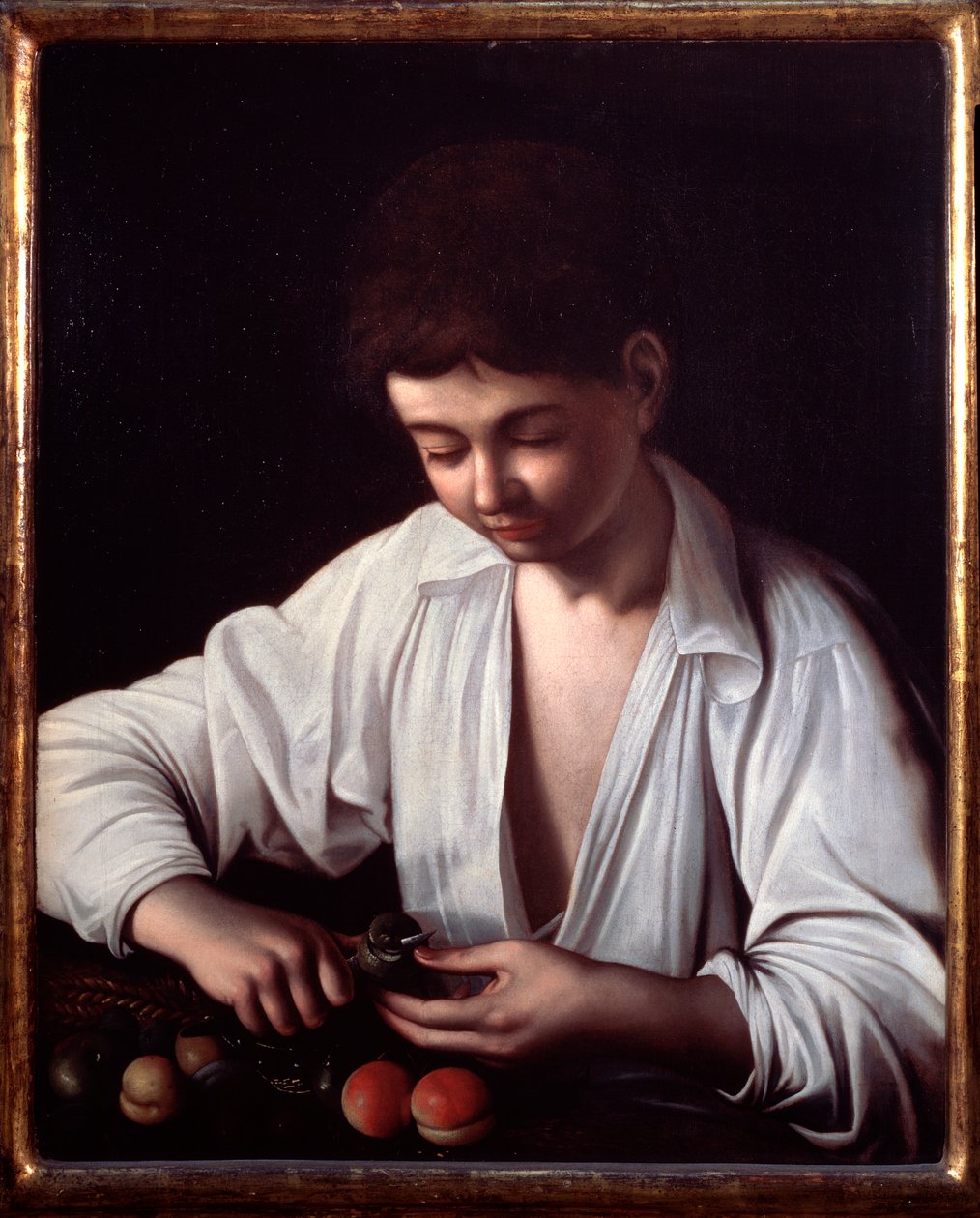 Bir meyve soyan bir çocuk by Michelangelo Merisi da Caravaggio
